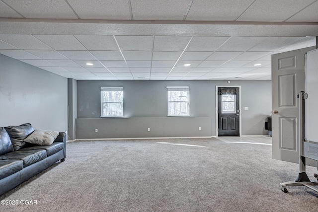 carpeted living room with a drop ceiling