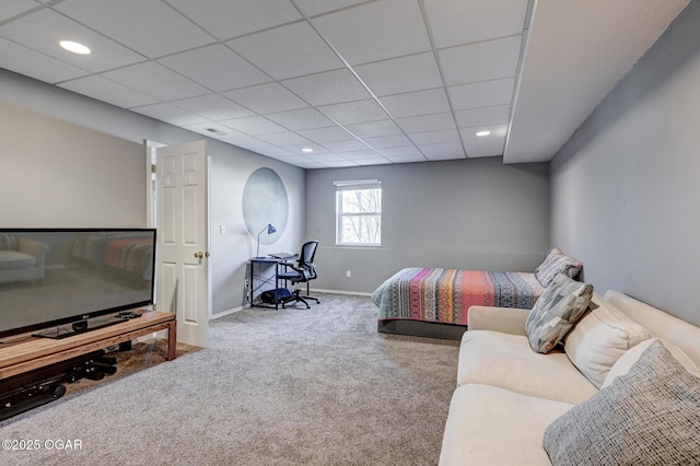 bedroom with carpet flooring and a paneled ceiling