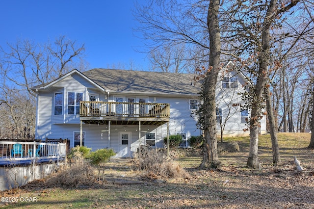 rear view of property with a pool side deck