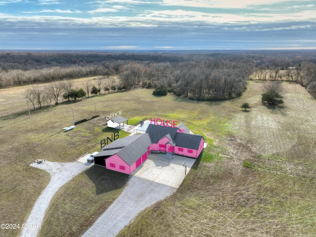 birds eye view of property featuring a forest view and a rural view