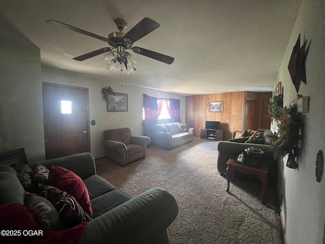 living room featuring ceiling fan, carpet floors, and wooden walls