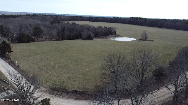 drone / aerial view featuring a water view and a rural view