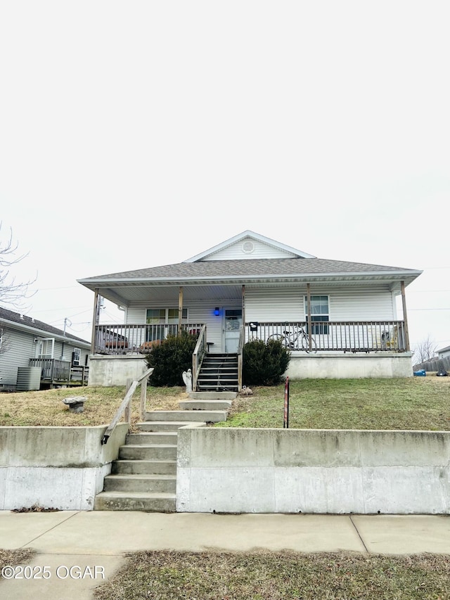 view of front of property with a front yard and covered porch