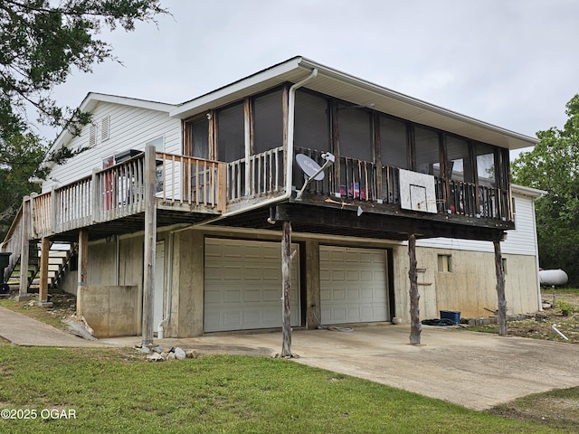979 S Matherly Rd, Protem, MO 65733 - rear view of property featuring a garage, concrete driveway, stairs, and a wooden deck
