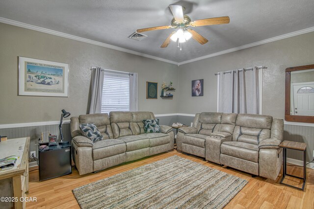 615 E 15th St, Joplin, MO 64801 - living room featuring light wood-type flooring, a ceiling fan, visible vents, and crown molding