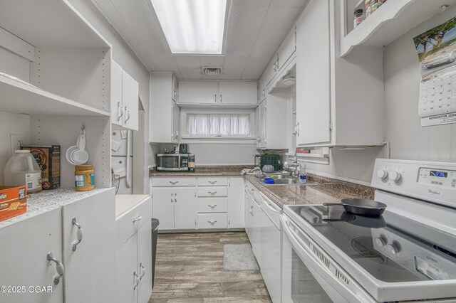 615 E 15th St, Joplin, MO 64801 - kitchen featuring white appliances, light wood-style flooring, white cabinets, and light countertops