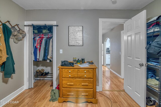 615 E 15th St, Joplin, MO 64801 - bedroom with arched walkways, light wood-style flooring, baseboards, a spacious closet, and a closet