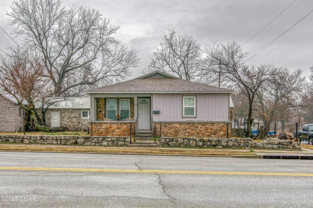 615 E 15th St, Joplin, MO 64801 - view of front facade featuring a shingled roof and stone siding