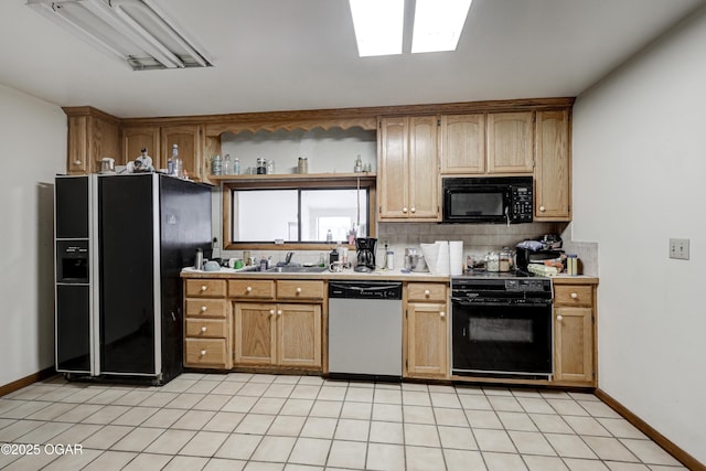 kitchen featuring light tile patterned flooring, sink, backsplash, and black appliances