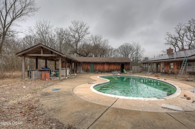 view of pool featuring a patio and a diving board