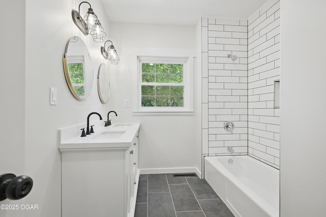 540 E 4th St, Baxter Springs, KS 66713 - bathroom with tile patterned floors, vanity, washtub / shower combination, and baseboards