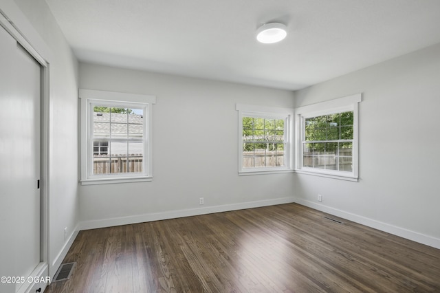 540 E 4th St, Baxter Springs, KS 66713 - spare room with dark wood finished floors and baseboards