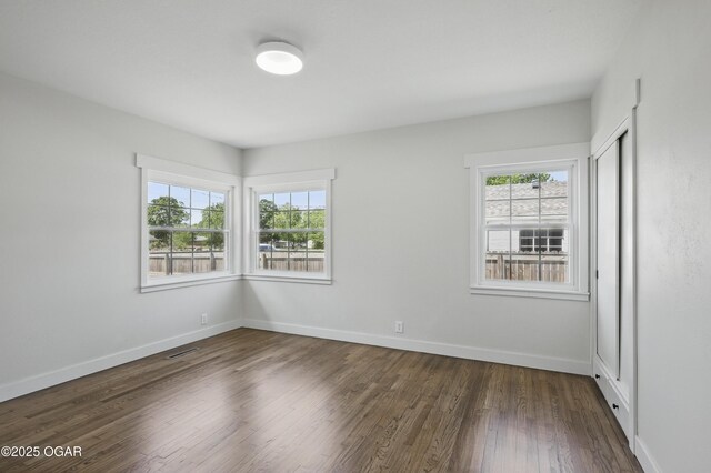 540 E 4th St, Baxter Springs, KS 66713 - spare room featuring wood finished floors and baseboards