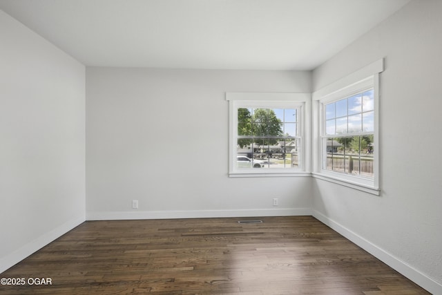540 E 4th St, Baxter Springs, KS 66713 - spare room with dark wood-style flooring and baseboards