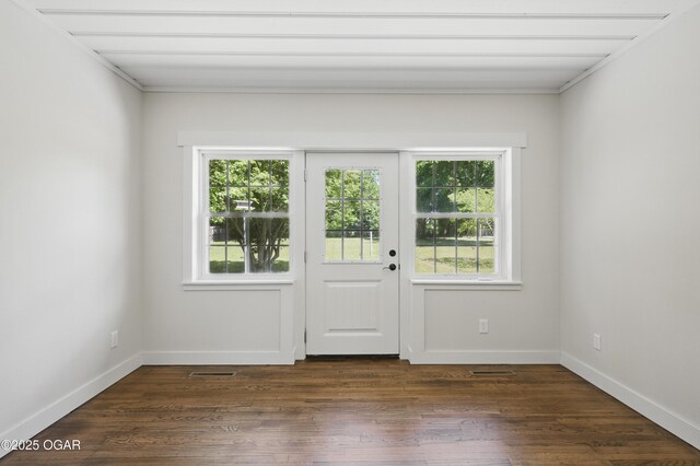 540 E 4th St, Baxter Springs, KS 66713 - doorway featuring healthy amount of natural light, dark wood-type flooring, and baseboards