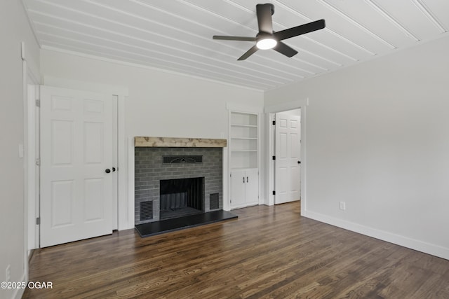 540 E 4th St, Baxter Springs, KS 66713 - unfurnished living room featuring wood finished floors, ceiling fan, a brick fireplace, baseboards, and built in shelves