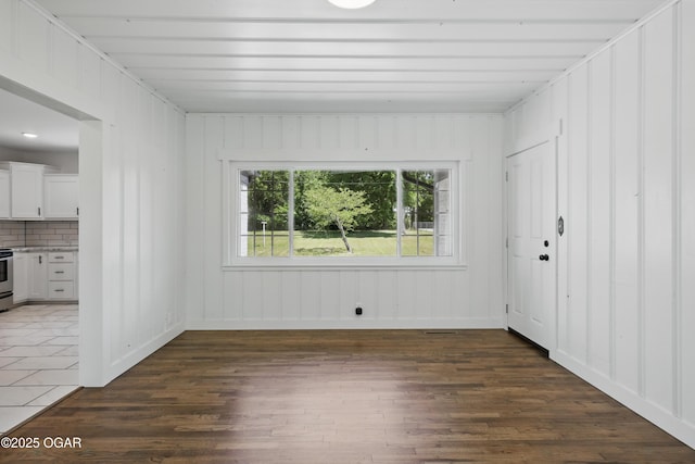 540 E 4th St, Baxter Springs, KS 66713 - spare room featuring dark wood-style flooring
