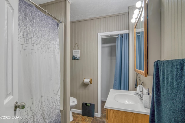 bathroom featuring vanity, a textured ceiling, and toilet