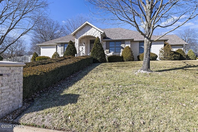 ranch-style home featuring a front yard