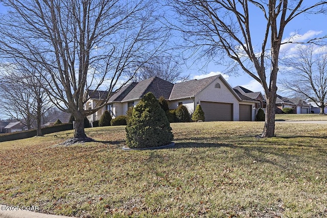 view of home's exterior with a garage and a yard