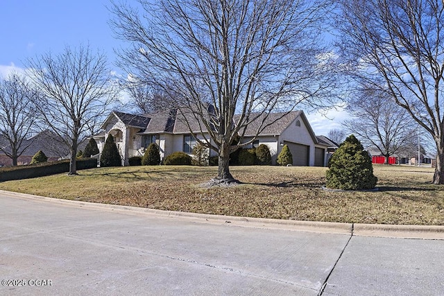 view of front of home featuring a garage and a front yard