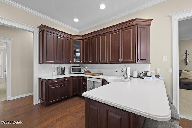 kitchen featuring sink, stainless steel dishwasher, dark hardwood / wood-style floors, kitchen peninsula, and backsplash