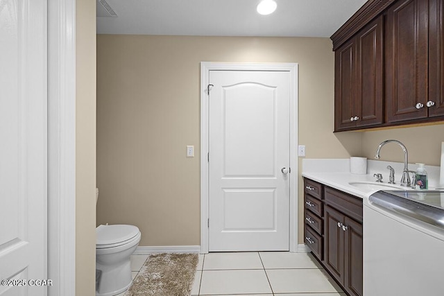 laundry area with sink and light tile patterned floors