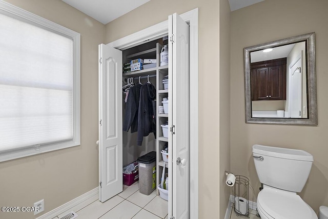 bathroom with tile patterned floors and toilet