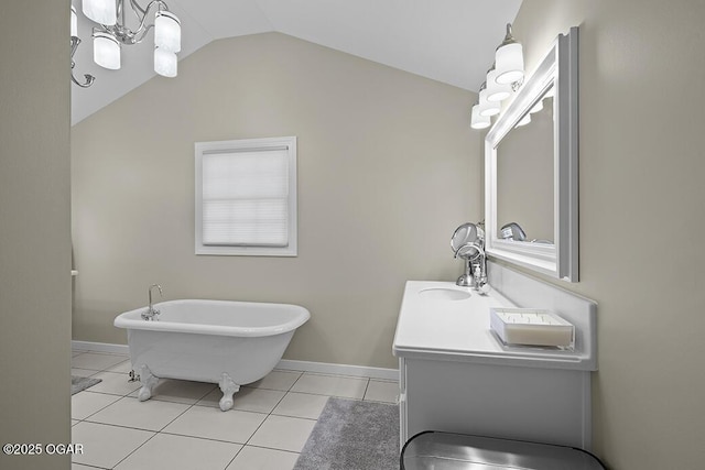 bathroom with tile patterned flooring, a bathing tub, lofted ceiling, and vanity