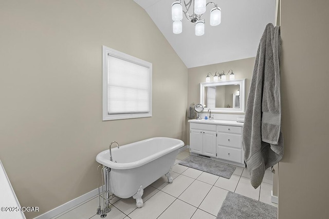 bathroom featuring a bathing tub, lofted ceiling, a chandelier, vanity, and tile patterned floors