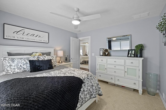 bedroom with ceiling fan and light carpet