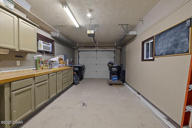 garage featuring a garage door opener and a wall mounted AC