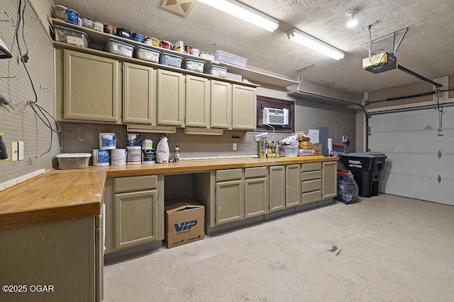 garage featuring a garage door opener and a wall unit AC