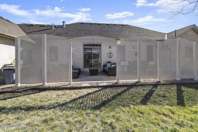 rear view of property with a patio area and a lawn