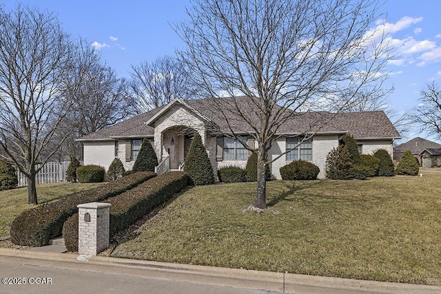 ranch-style home featuring a front yard