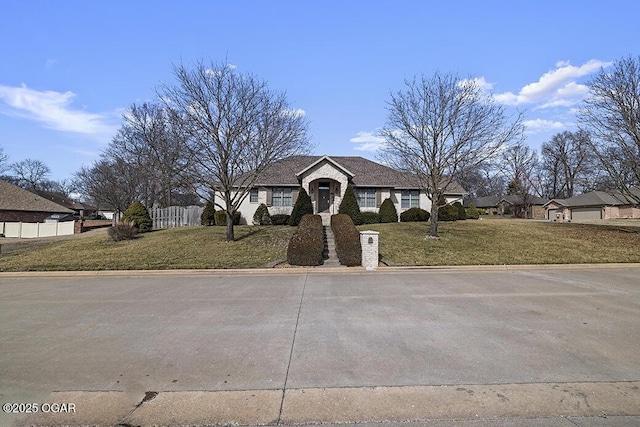 ranch-style house featuring a front lawn