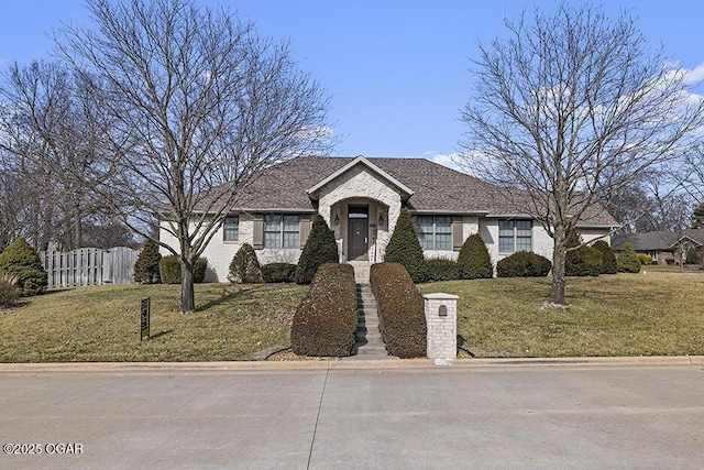 ranch-style home with a front lawn