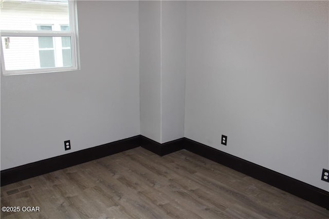 unfurnished room featuring dark hardwood / wood-style floors