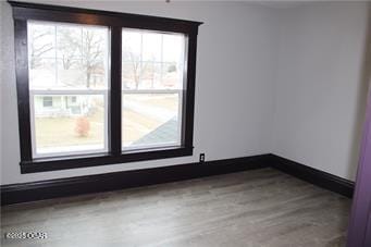 unfurnished room with hardwood / wood-style floors