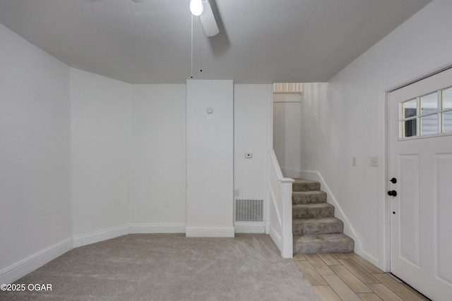 foyer entrance with light hardwood / wood-style flooring and ceiling fan