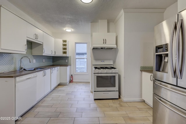 kitchen featuring white appliances, sink, and white cabinets