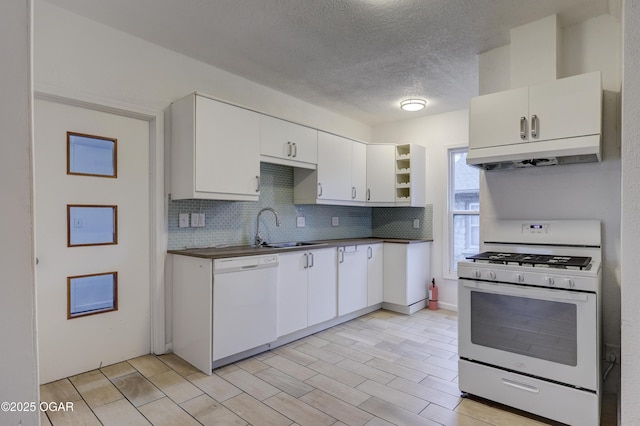 kitchen with white cabinetry, sink, and white appliances