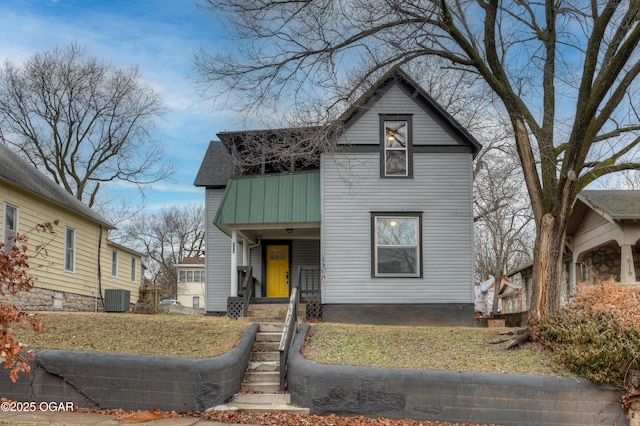 view of property with central AC unit, a front lawn, and a porch