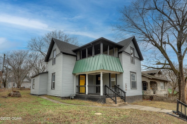 view of front of house featuring a porch and a front yard