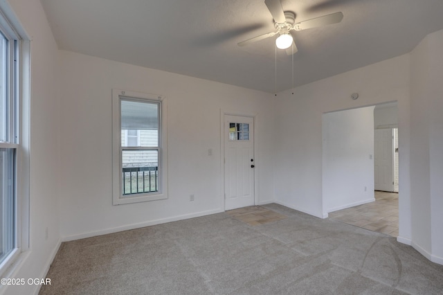 empty room featuring light carpet and ceiling fan