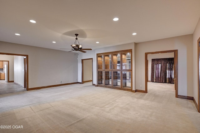 carpeted spare room featuring ceiling fan