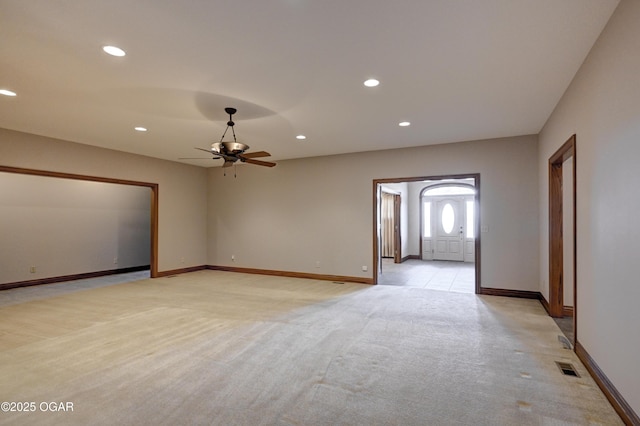 carpeted empty room featuring ceiling fan