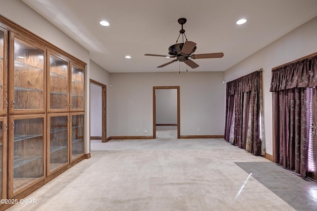 carpeted empty room featuring ceiling fan