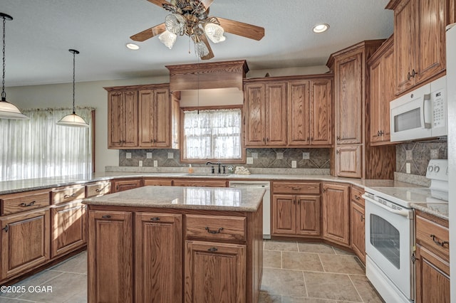 kitchen with sink, a center island, hanging light fixtures, white appliances, and backsplash