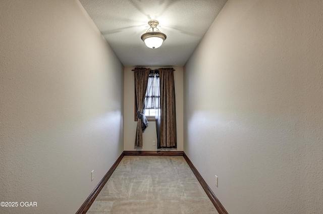 carpeted spare room featuring a textured ceiling